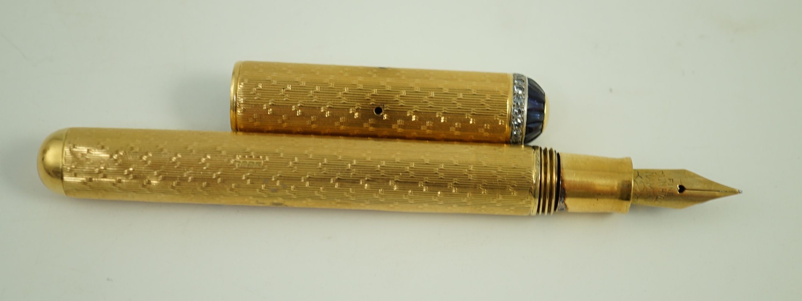 A late 1930's 18ct gold cased and sapphire and diamond set side lever fountain pen, 11cm